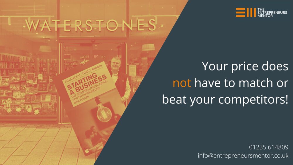 Mike holds a giant book cover in front of Waterstones bookshop, where you can buy The FT Guide to Starting a Business.
